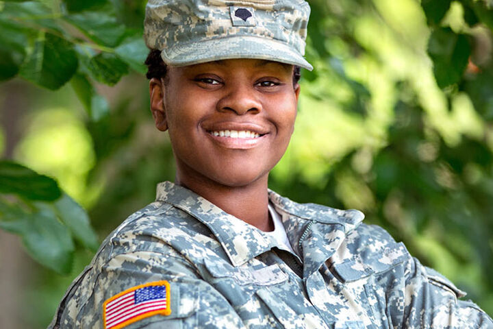 Female soldier wearing operational camouflage pattern uniform.